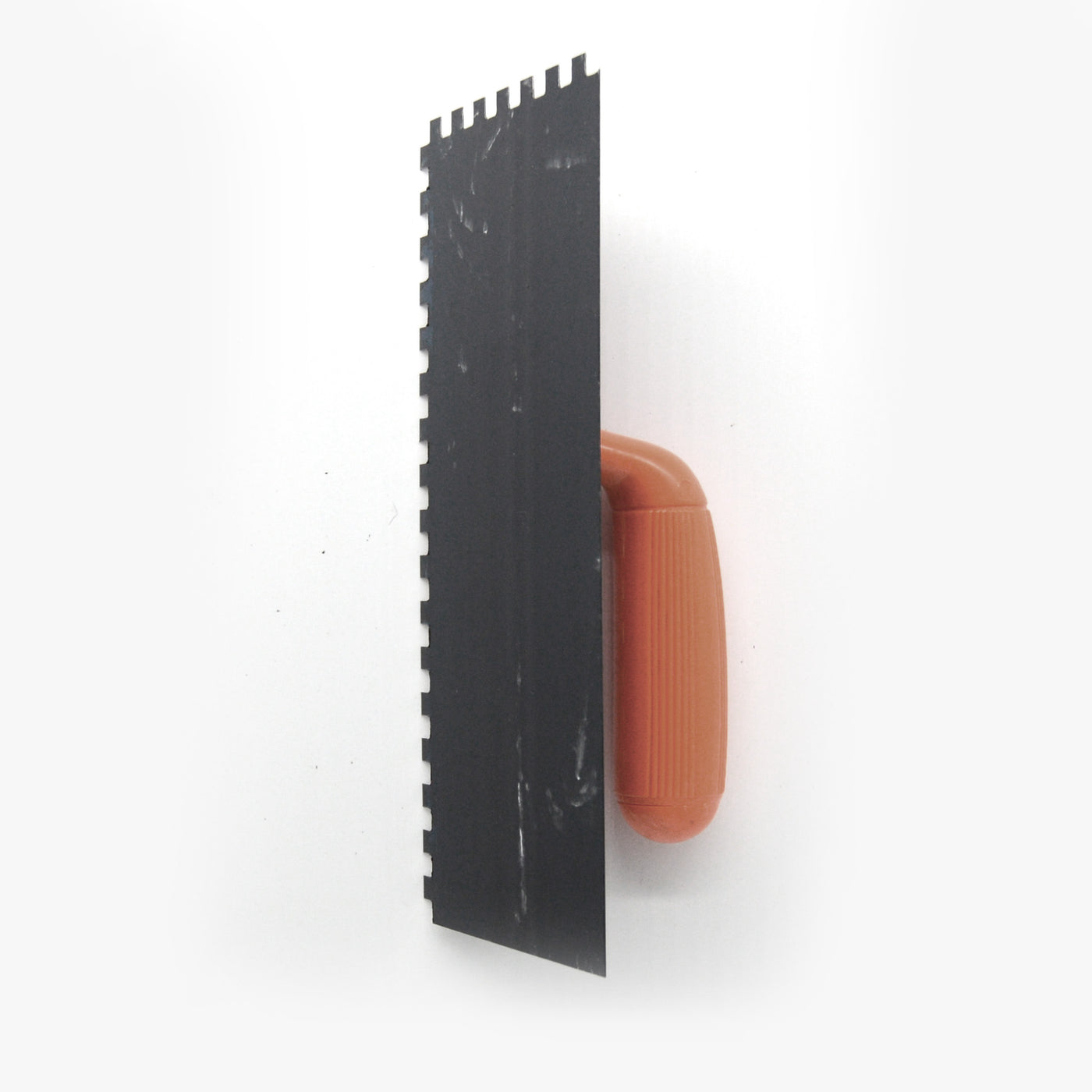 Notched trowel for brick facing adhesive